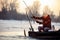 Ice fishing on frozen lake- smiling fisherman catch fish pike