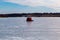 Ice fishing; frozen lake surface in winter with a red ice shanty or ice hut on the lake.