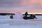 Ice fishing tent and snowmobile with fishermen. Landscape winter. Ice fishing is a popular sport.