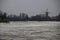 Ice flakes on river Hollandse IJssel at nieuwerkerk aan den IJssel during winter in the Netherlands with windmill