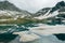 Ice floe Drifts at mountain cold lake. snowy peaks reflected in water