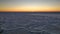 Ice floes on the winter Barents Sea and a colorful sunset.