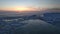 Ice floes on the winter Barents Sea and a colorful sunset.