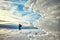 Ice formations at sunset, cross-country skier silhouette in dist