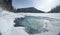 Ice free snow-bound mountain river in winter