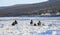 Ice freshwater fishing on coastal thin ice at the beginning of winter
