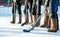 Ice hockey in felt boots, horizontal shot of the legs of the sport team.