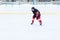 Ice hockey skater with stick on rink