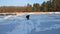 Ice hole fishing at winter lake, man in warm clothes with rod