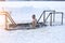 Ice hole on the lake. A man bathes in ice water