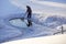 Ice hole in the lake in winter is equipped with a ladder for launching. Man cleans ice hole