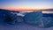 Ice hummocks on a background of of Lake Baikal dawn panorama