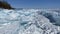 Ice hummocks of Lake Baikal covered with snow. Large, impenetrable chunks of ice