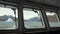 Ice and iceberg from porthole window of yacht in Arctic Ocean.