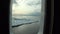 Ice and iceberg from porthole window of yacht in Arctic Ocean.