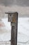 Ice icicles Covered bird house on fence post in November