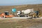 Ice Rink, cement mixer and excavator are on the road leading to the bridge being built Kerch