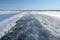 Ice road on a frozen reservoir in the winter