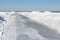 Ice road melting on a frozen reservoir in winter