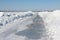 Ice road melting on a frozen reservoir in winter