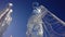 Ice sculptures of standing angels torsos with a wings. Artwork over blue sky.