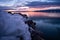 Ice on the side of Utah lake during sunset with glassy water