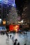 Ice skaters glide past the lighted Christmas tree in Rockefeller Center, New York City