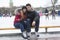 Ice skating couple having winter fun on ice skates