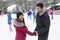 Ice skating couple having winter fun on ice skates