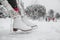 Ice skating woman getting ready lacing leather skates boots to go skate at outside rink nature park. Winter sport fun