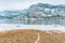 Ice and snow on Vaseux Lake with mountains in distance