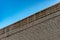 Ice stalactite. Roof of old building covered with sharp icicles. Large icicles hanging from the roof of an old brick