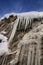 Ice stalactites under blue sky