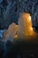 Ice stalagmites illuminated by candles inside the marble mine.