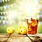 Ice tea with ice and lemon fruit with blurred spring background.