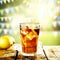 Ice tea with ice and lemon fruit with blurred spring background.