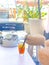 Ice tea with lemon with black straw on natural white table in summer beach bar