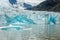 Ice wall and icebergs in Fjallsarlon glacier lagoon, abstract landscape Iceland