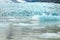 Ice wall and icebergs in Fjallsarlon glacier lagoon, abstract landscape Iceland