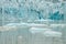 Ice wall and icebergs in Fjallsarlon glacier lagoon, abstract landscape Iceland