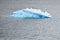 Iceberg with Adelie penguins upside in Antarctic Ocean near Paulet Island Antarctica.