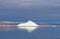 Iceberg against Barren Rock and Dark Skies