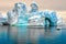 Iceberg in Antarctica, ice castle with Zodiac in front. Huge iceberg sculptured like fairytale castle