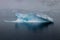 Iceberg in calm sea. Blue Ice.