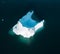 An Iceberg Of Colossal Size In The Form Of A Castle seen from above aerial. Floats In The Cold Waters Of Greenland in