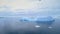Iceberg float in clear water ocean aerial view