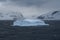 Iceberg glowing in an overcast dawn