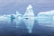 Iceberg graveyard in Antarctica with many huge mass of ice stranded offering spectacular polar landscape for tourists on zodiac