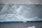 Iceberg, huge table iceberg, tabular iceberg with texture in dark rough Southern Ocean, Antarctica