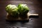 Iceberg lettuce on cutting board on wooden table background. Whole heads of fresh crisphead lettuce